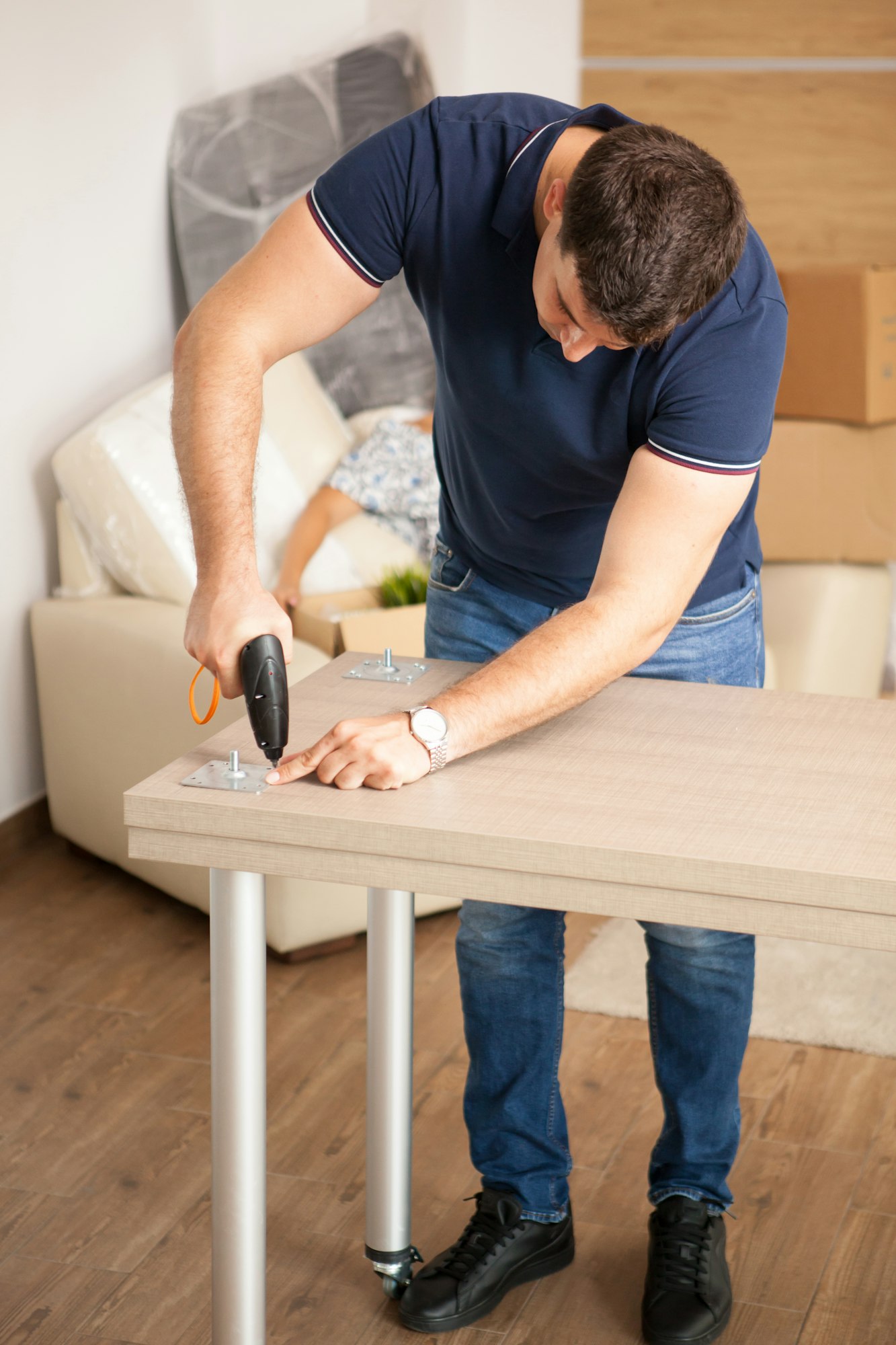 Man assembling furniture in their new flat